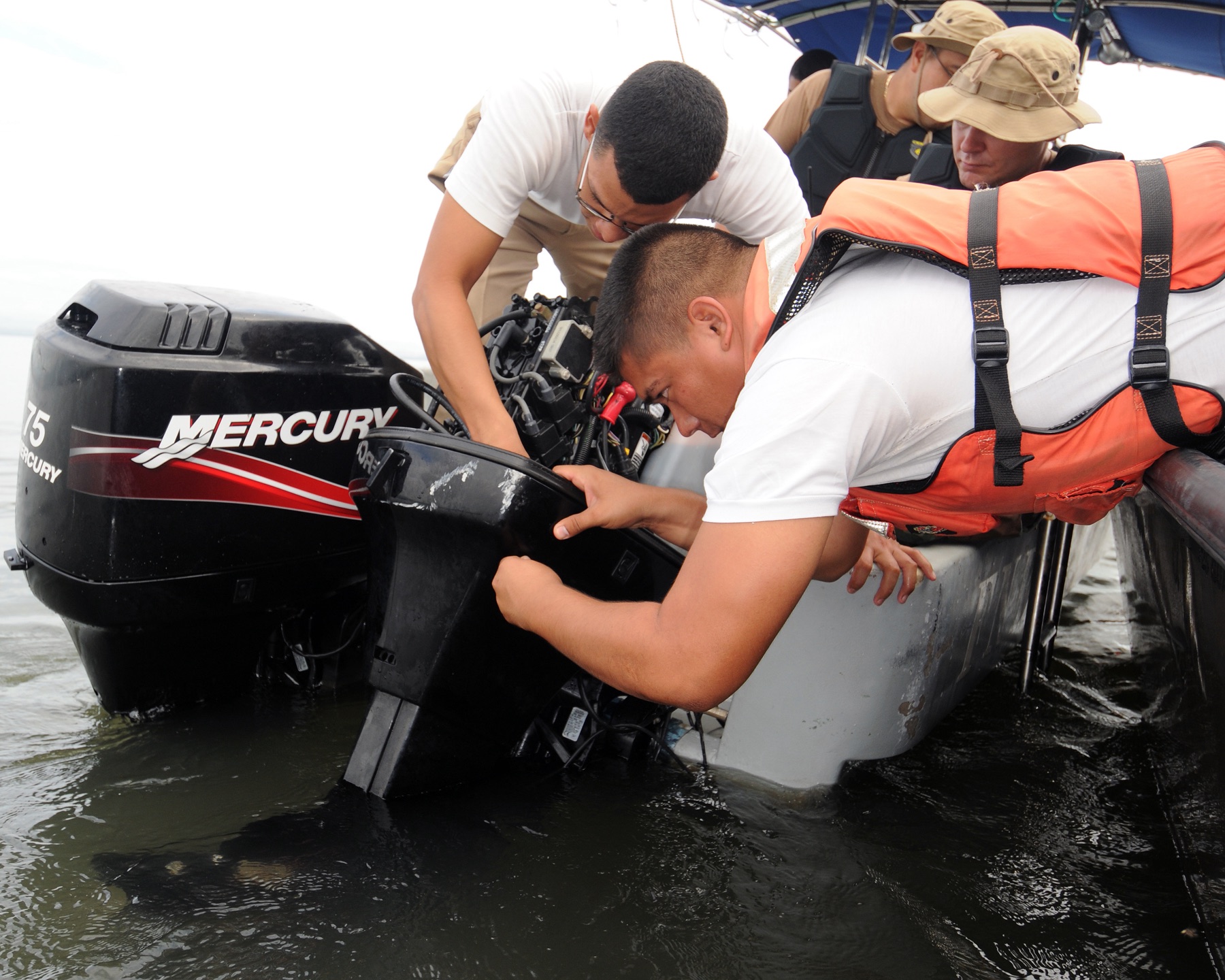 Technicians working on an outboard motor